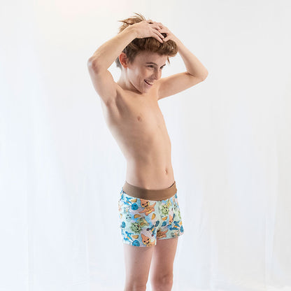 a boy modeling his wunderundies while messing with his hair on a white backdrop