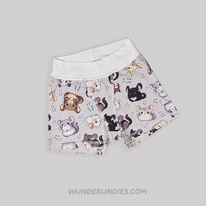 A pair of tagless children's boxer briefs by WunderUndies, featuring a light lavender-gray background with a playful all-over print of chinchillas. The waistband is solid white.