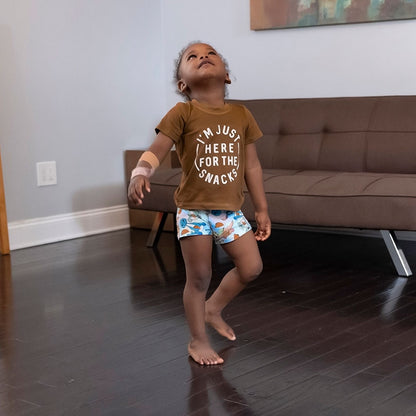 a young boy playing while modeling his wunderundies boxers