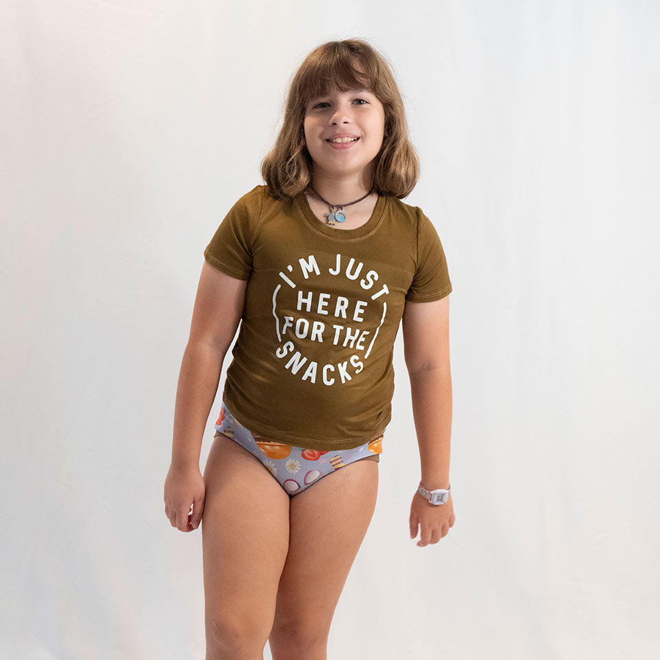 a girl modeling her wunderundies briefs on a white backdrop