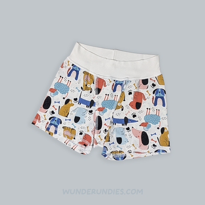 White boxer briefs with a colorful cartoon dog print, displayed flat on a solid gray background.