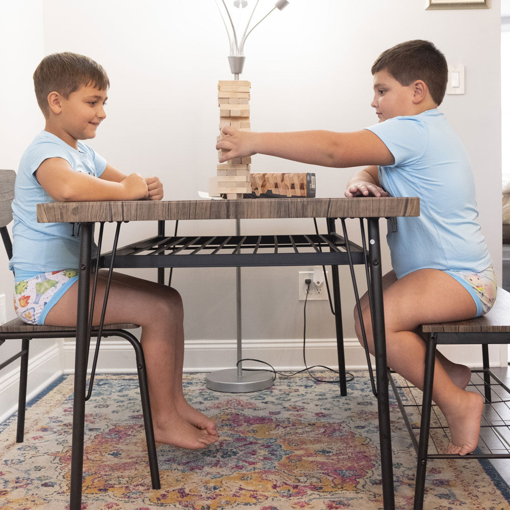 two young boys playing jenga at the kitchen table while wearing wunderundies briefs