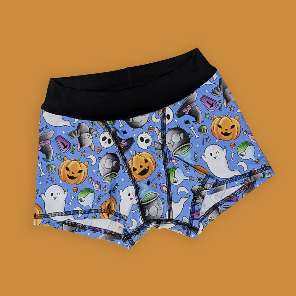 Halloween-themed boxer shorts with ghosts, pumpkins, and ghosts on a blue background 