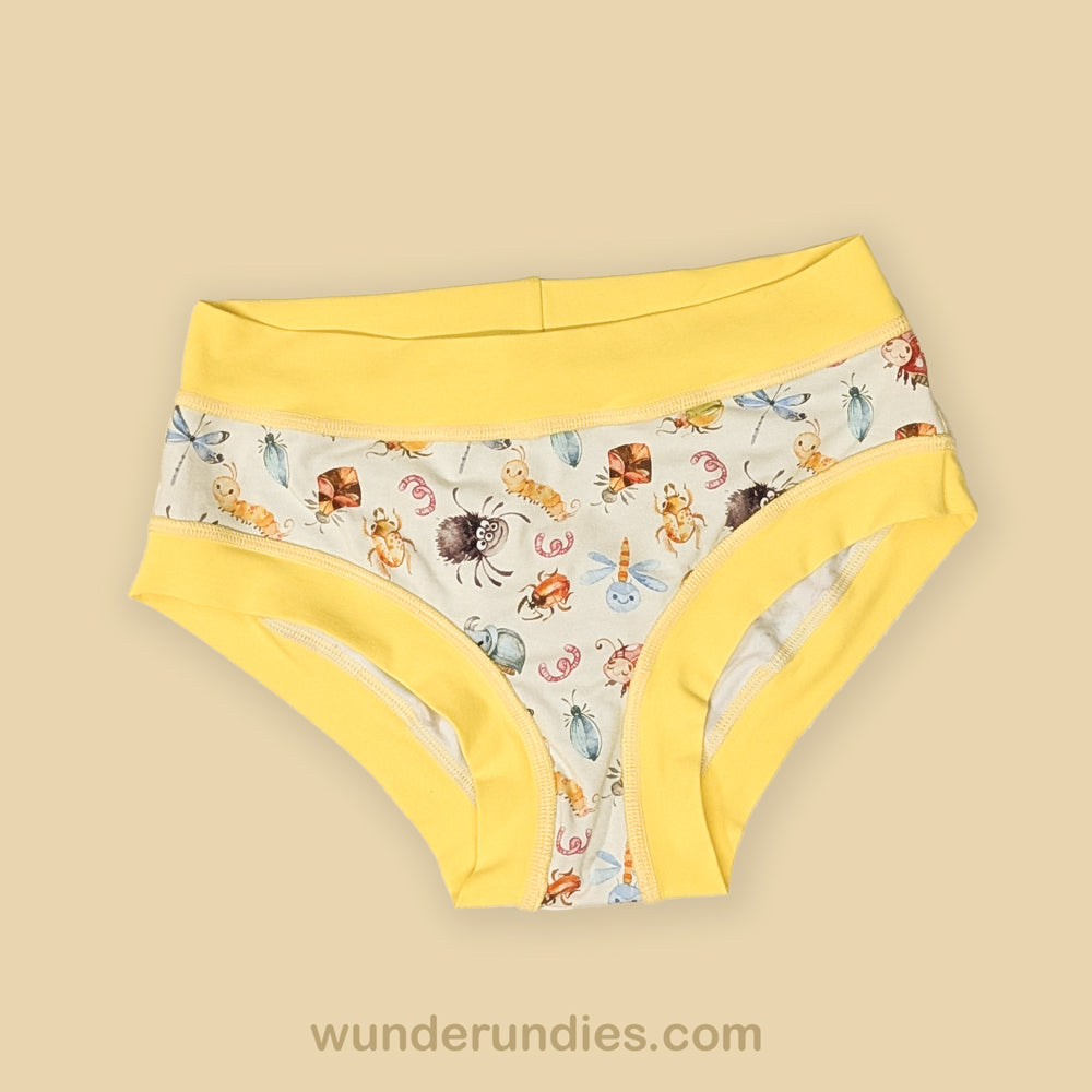 Pair of adult underwear with bug print and yellow accents on a beige background, featuring the brand 'wunderundies'.