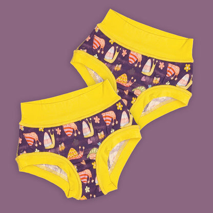 two pairs of flat seamed, sensory friendly underwear. they have yellow waistband and leg bands and feature a cute snail print on a purple background.