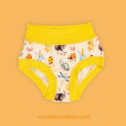 Children's underwear with a cute bug pattern and yellow trim on a beige background, featuring the brand 'wunderundies.com'.