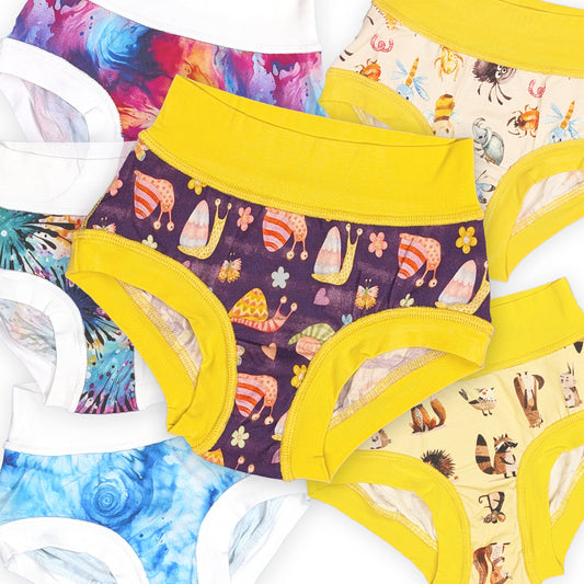 six pairs of sensory friendly briefs with the featured pair being purple with yellow waist and leg bands featuring a cute snail print in the center