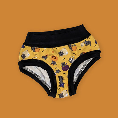 fun halloween themed sensory friendly underwear with a yellow background, black bands, and kitties