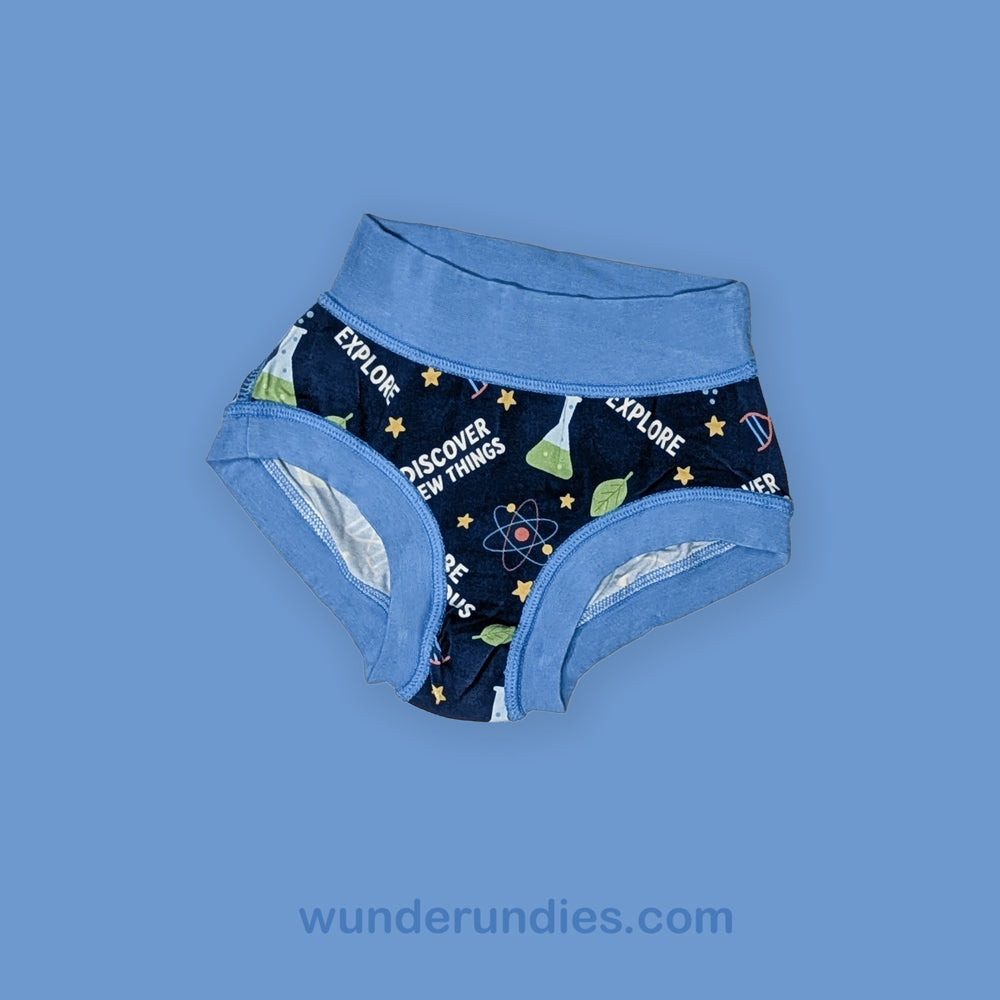 Children's underwear with science-themed design on a blue background, featuring the brand 'wunderundies.com'.