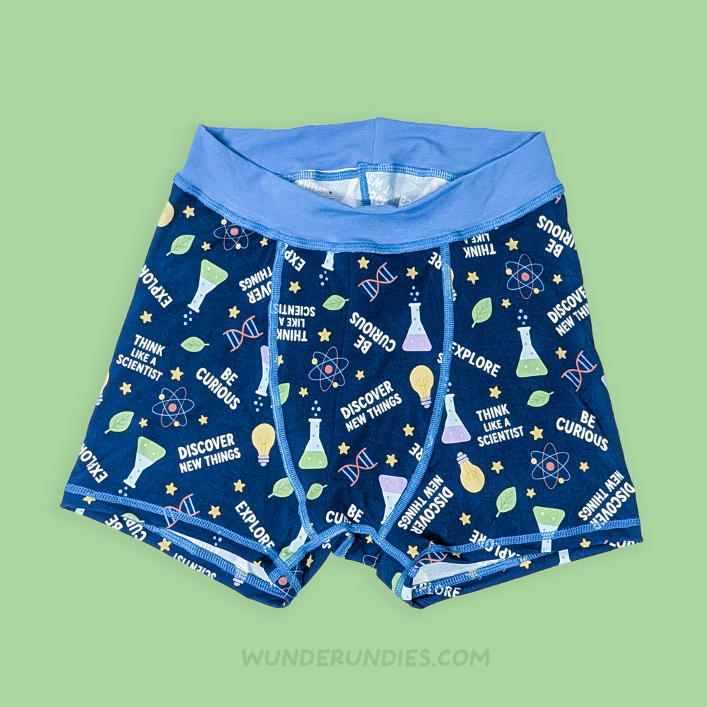 adult's underwear with science-themed print on a green background