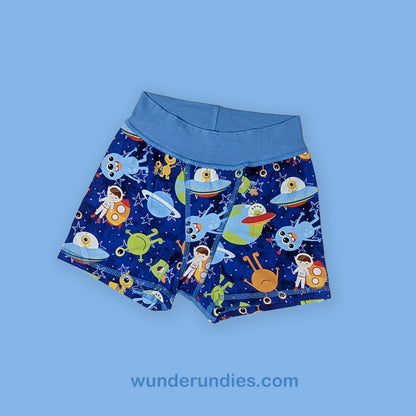 Children's boxer briefs with space-themed design on a blue background, featuring the brand 'wunderundies'.