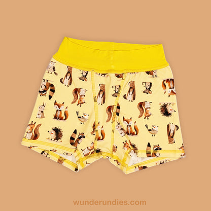 Children's underwear with a woodland animal pattern on a beige background