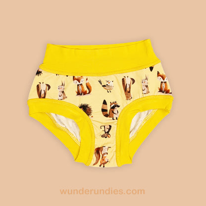 Yellow children's underwear with a woodland animal pattern on a beige background